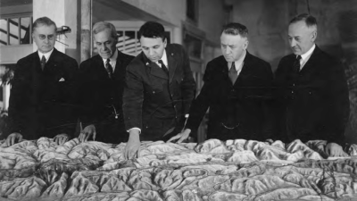 Ansel F. Hall and future park general manager Elbert Vail with Oakland, Berkeley, and Alameda County officials looking at map of future Tilden Regional Park in 1934
