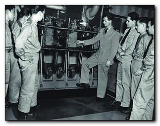 Students being instructed on parts of a reciprocating engine